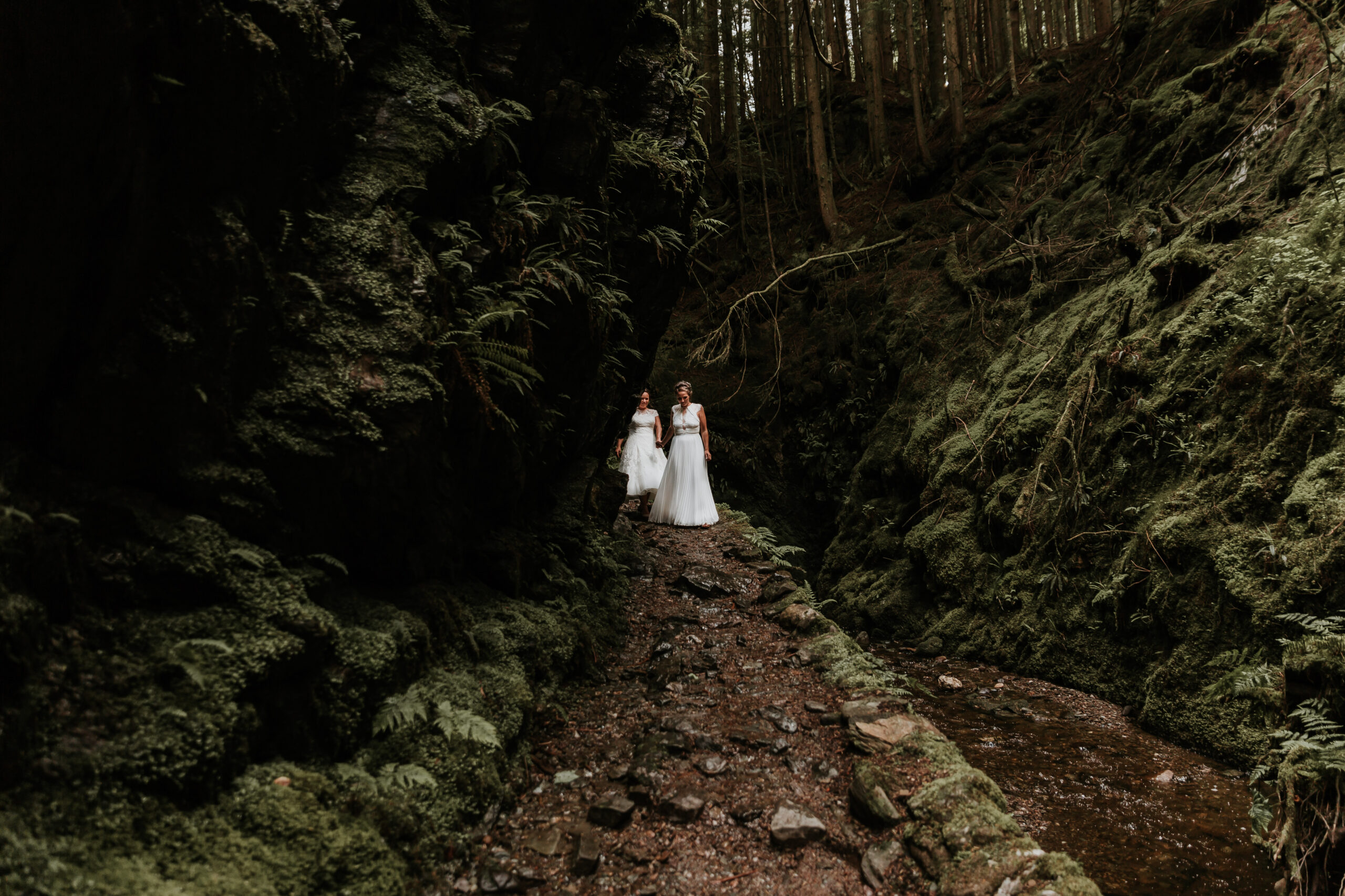 brides walking down a stoney path
