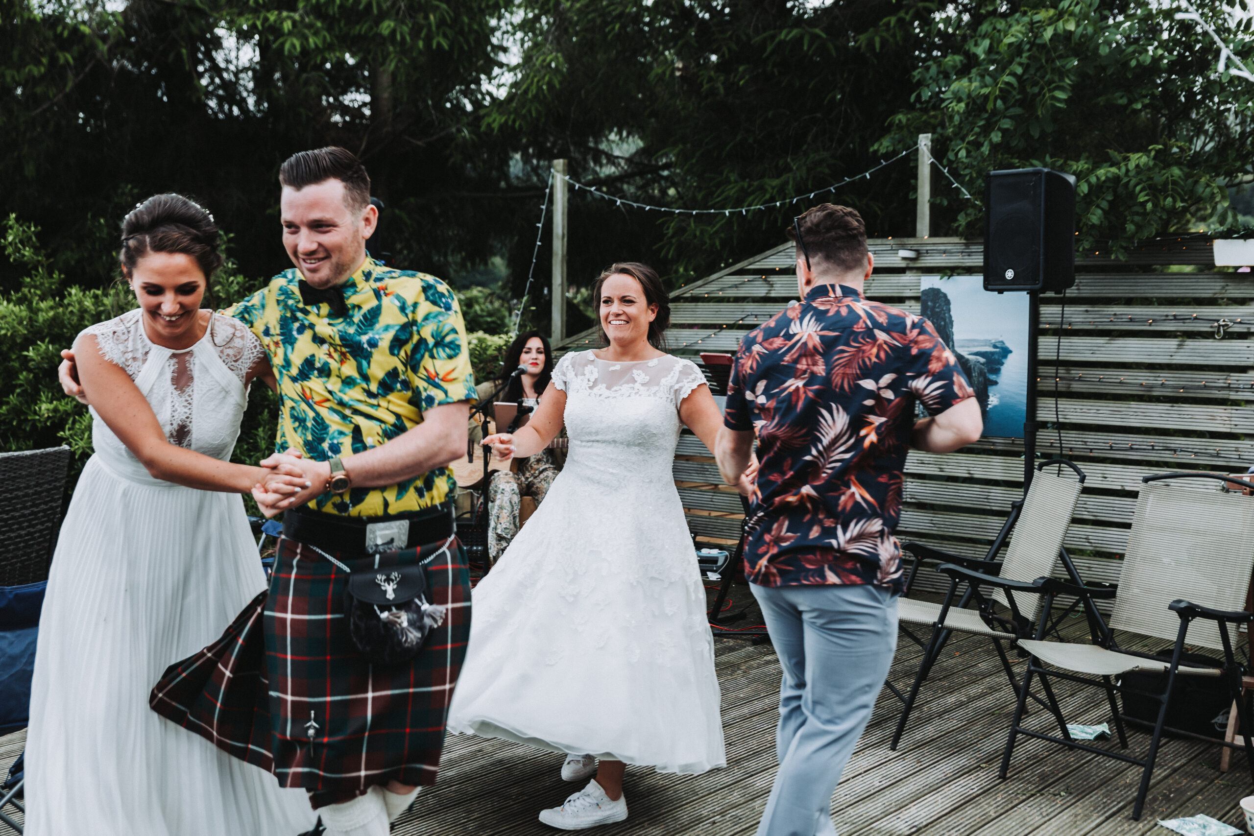 brides and guests dancing at lgbtq+ scotland wedding