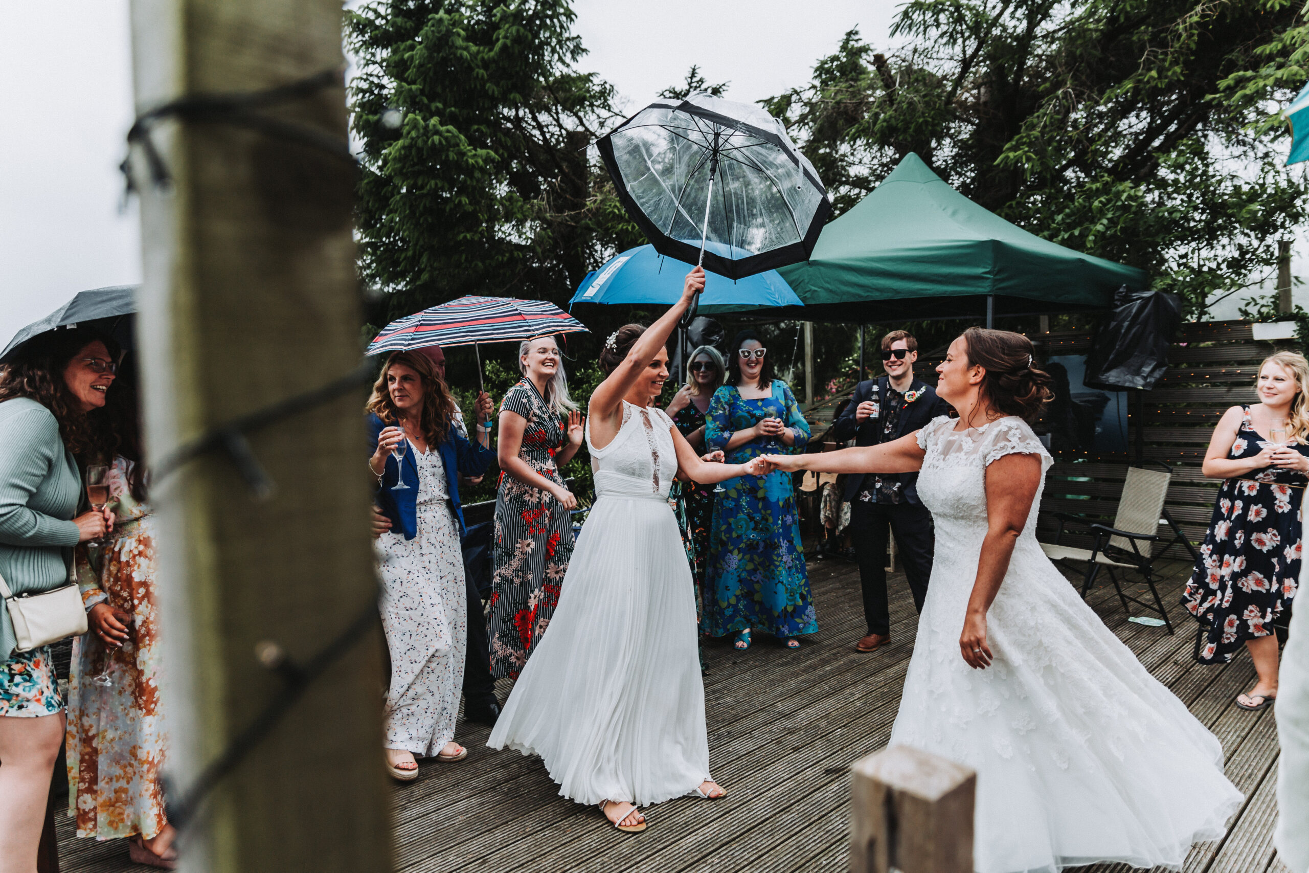 brides dancing in the rain