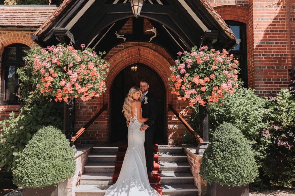 bride and groom outside careys manor
