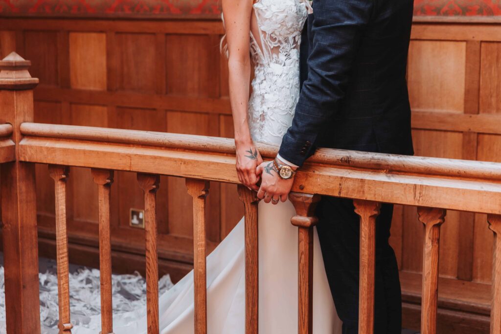 careys-manor-wedding-13 couples hands on a bannister