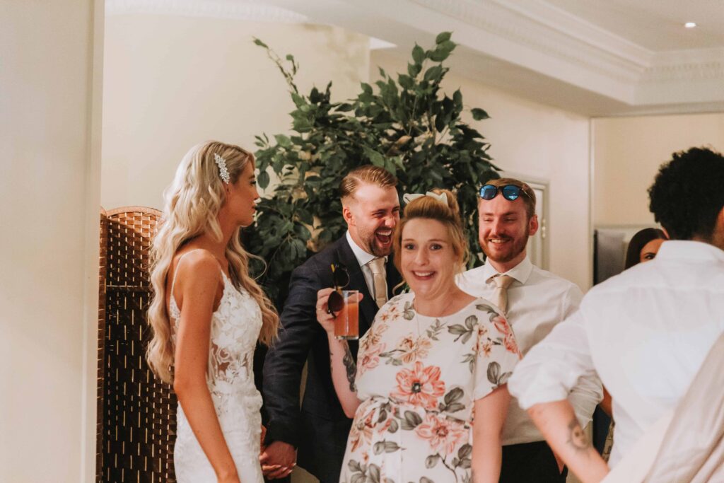 bride and grrom greeting guests inside