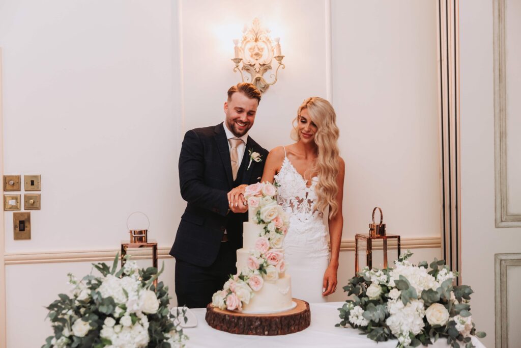 bride and groom cutting the cake