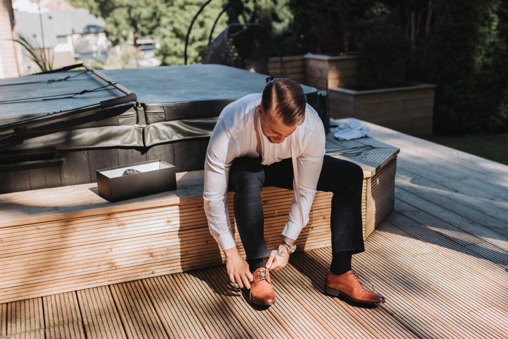 groom doing up his shoes