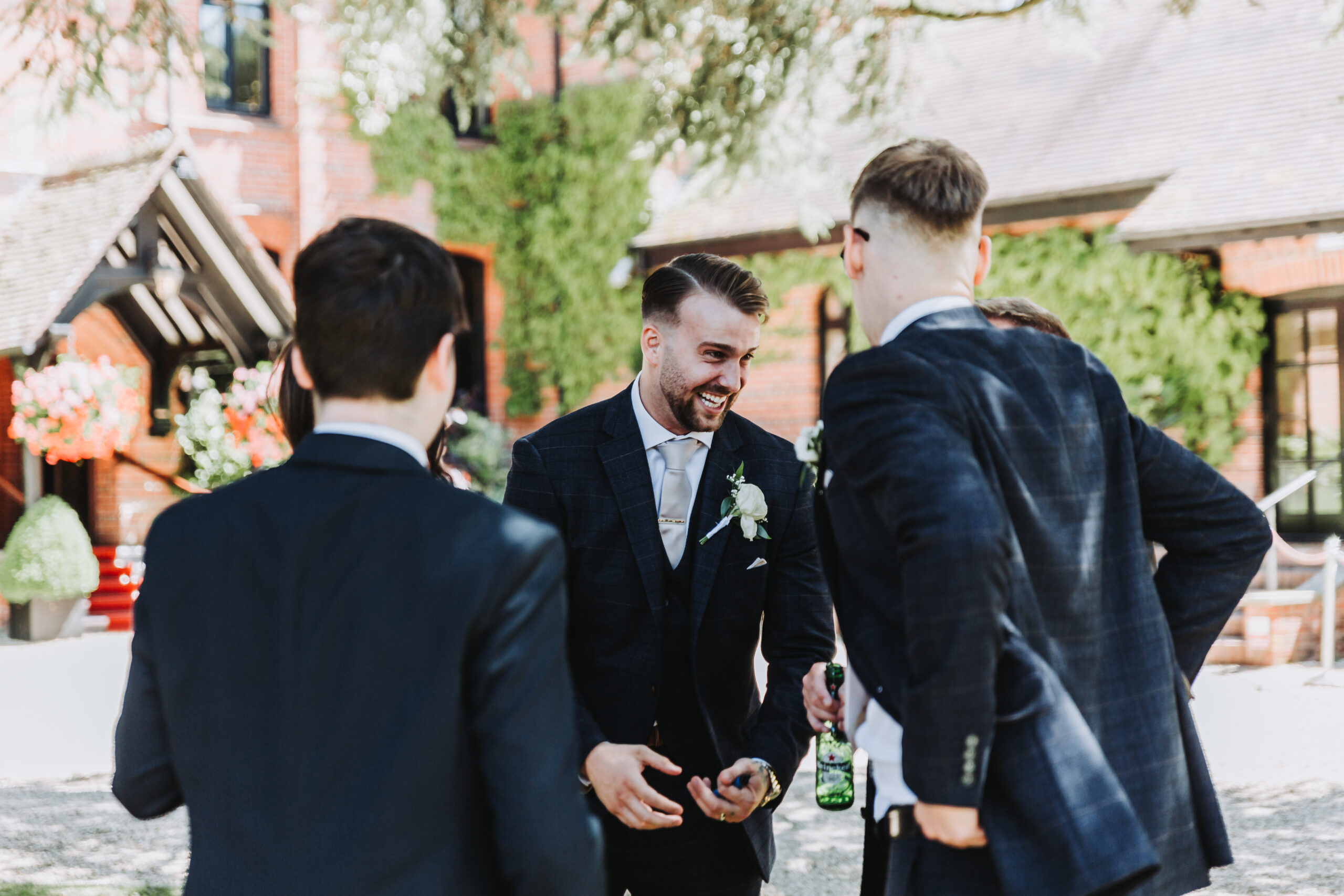 groom laughing with guests