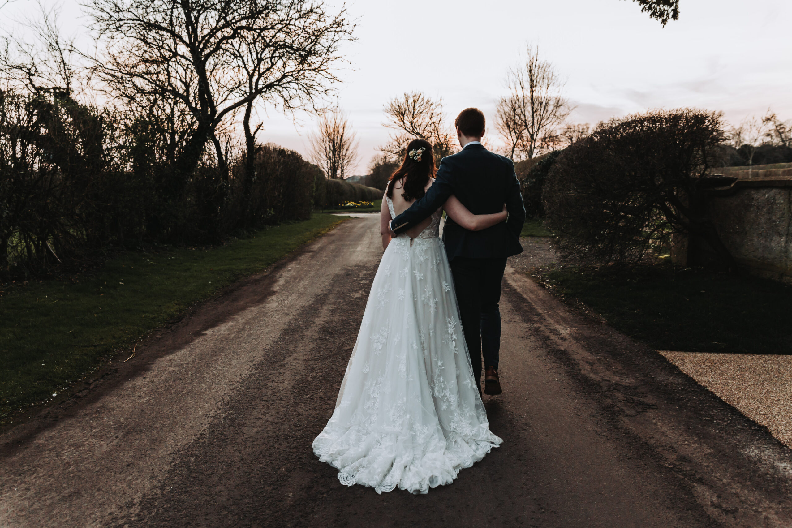 bride and groom walking down clock barn lane