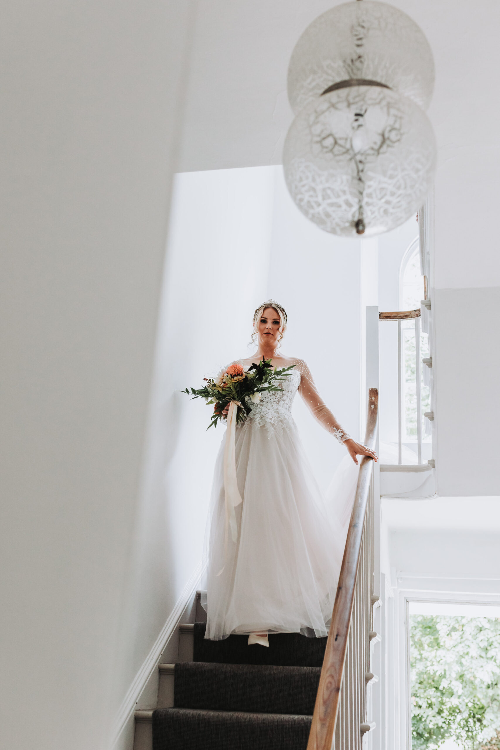 bride walking down the stairs at intimate cornish wedding
