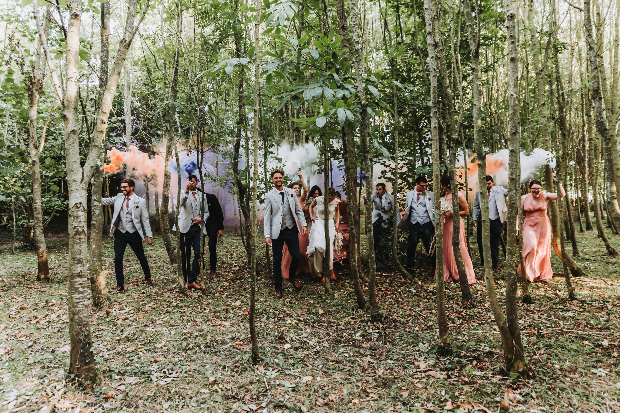bridal party walking through the woods