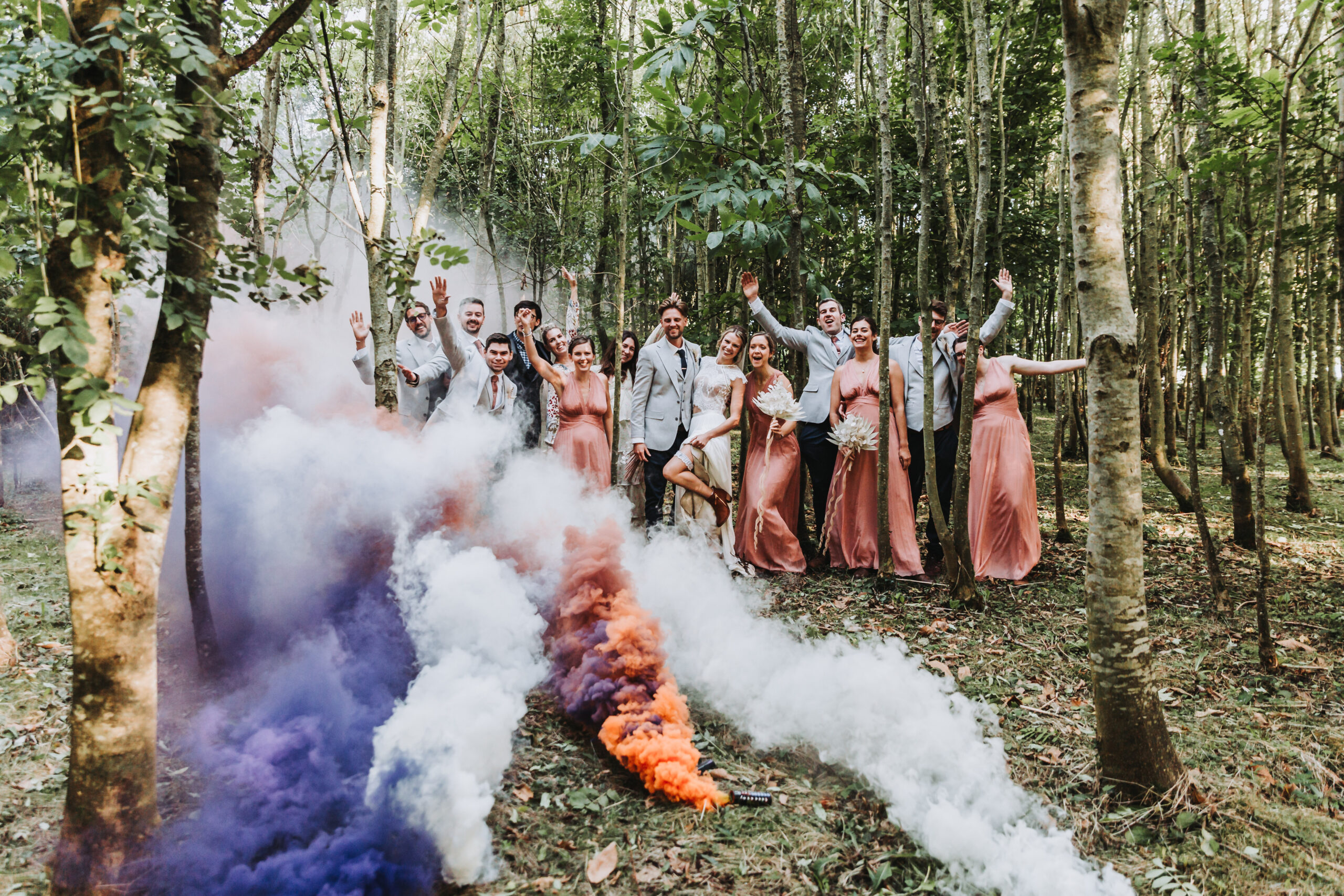 bridal party with smoke bombs