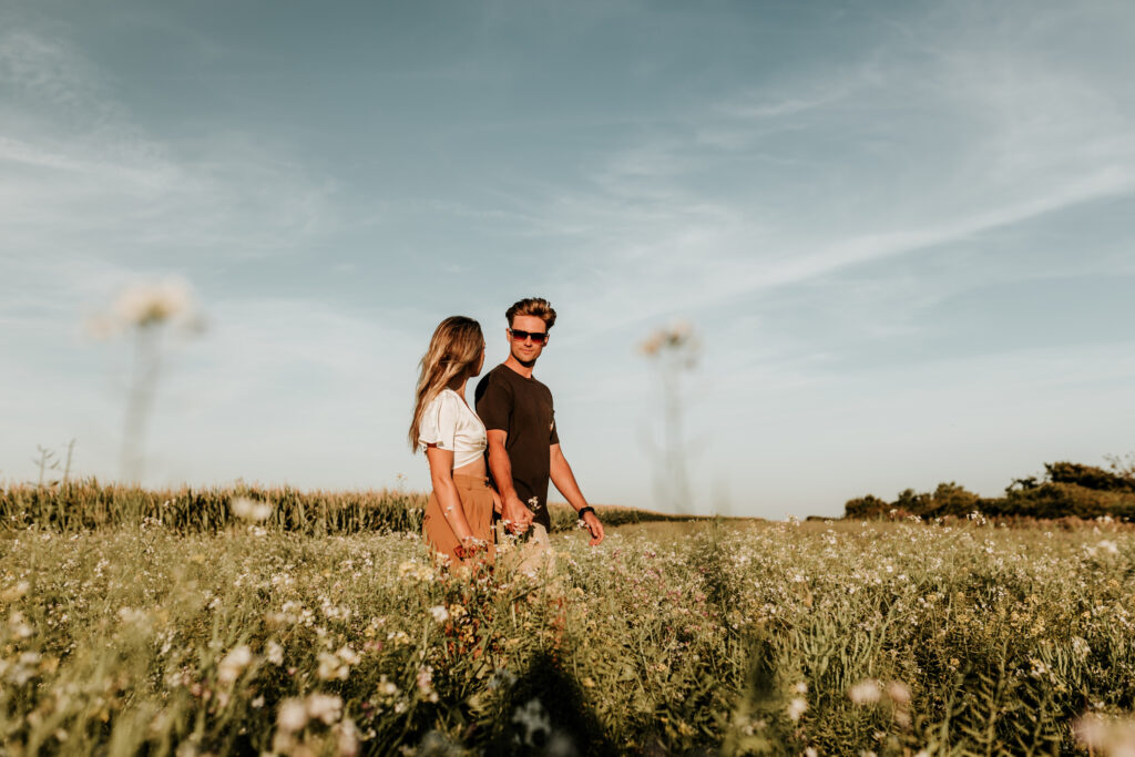couple walking through a field