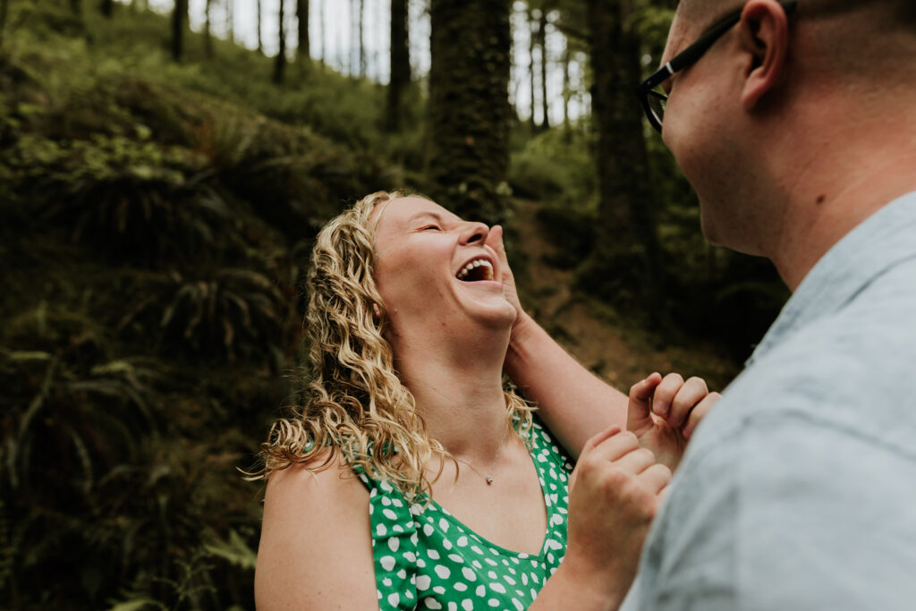 couple laughing at cornwall engagement photoshoot