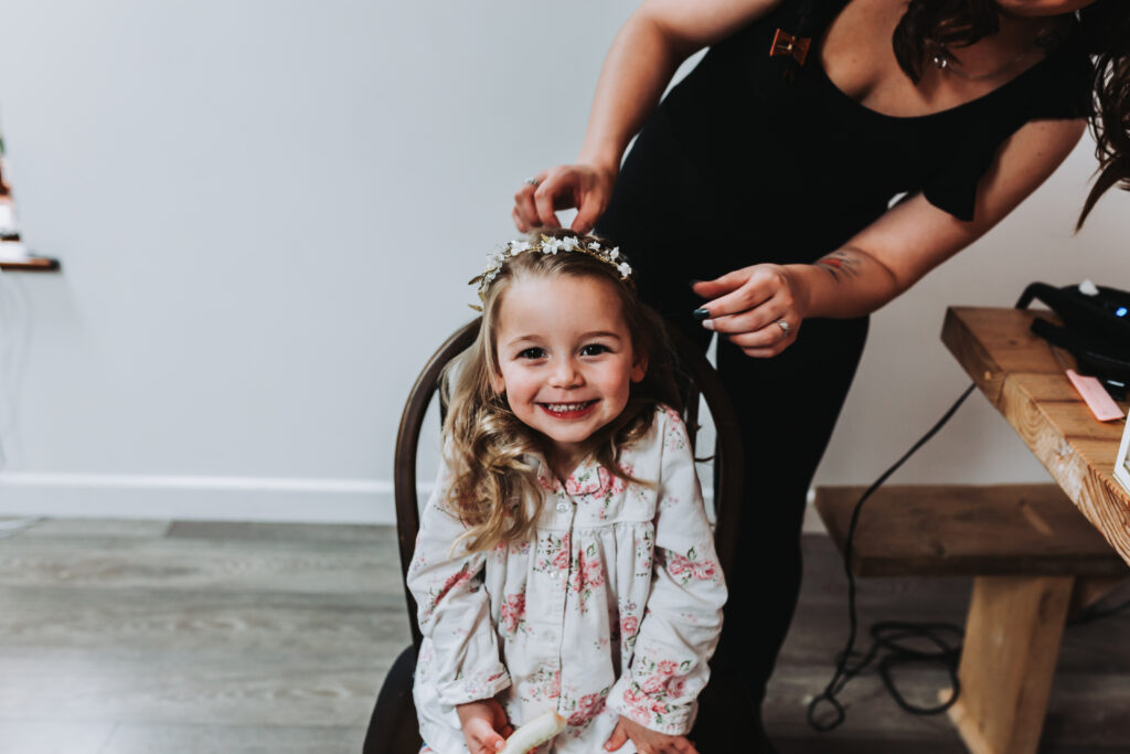 little girl having her hair done at cornwall wedding