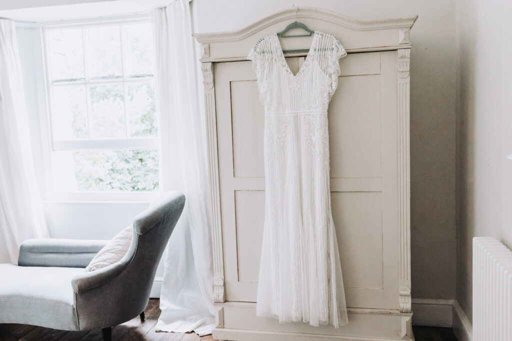 wedding dress hanging from wardrobe
