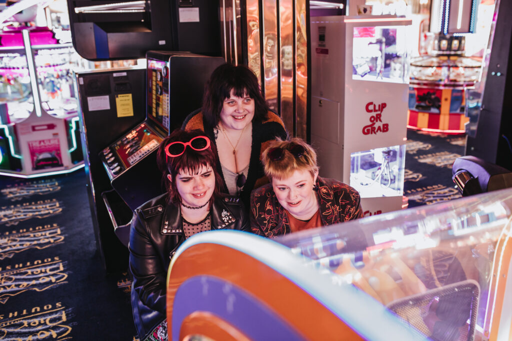 family in arcade by lgbtq+ photographer