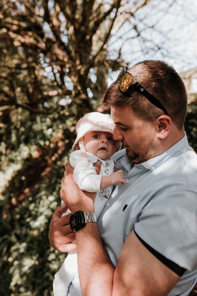 dad holding son a few weeks old