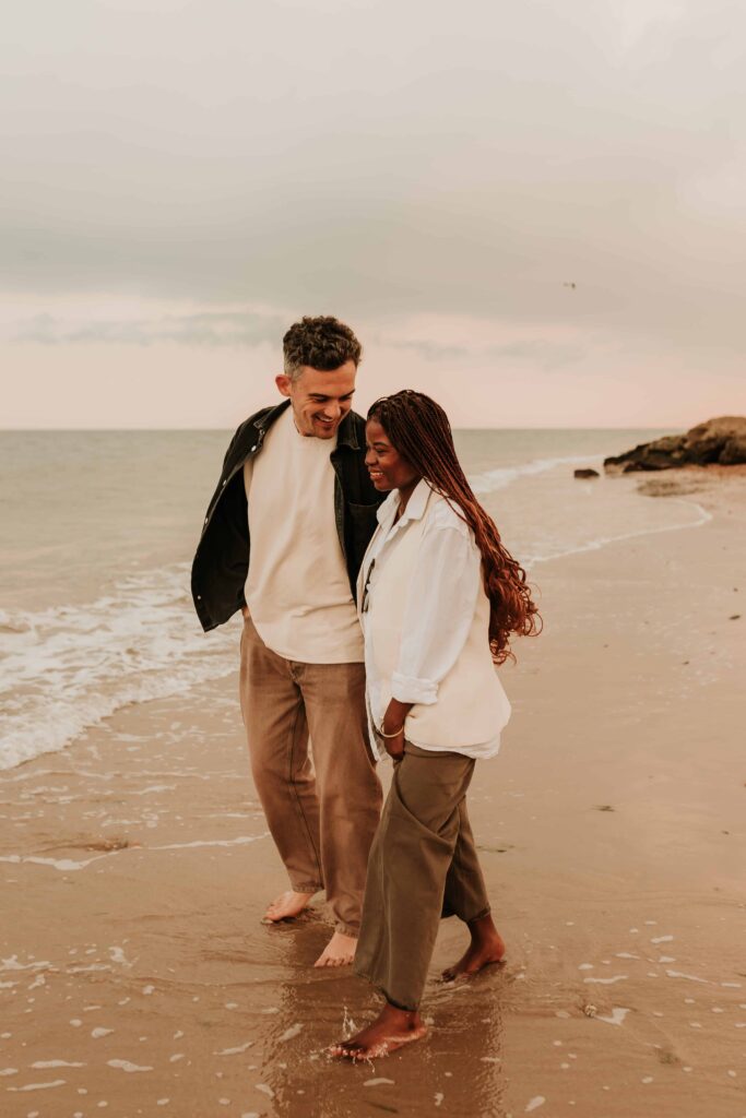 man and woman walking along the seafront bumping into each other