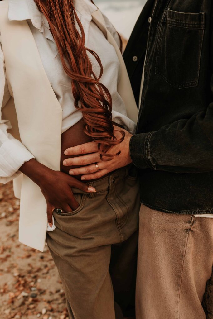 man with his hand on pregnant womans belly