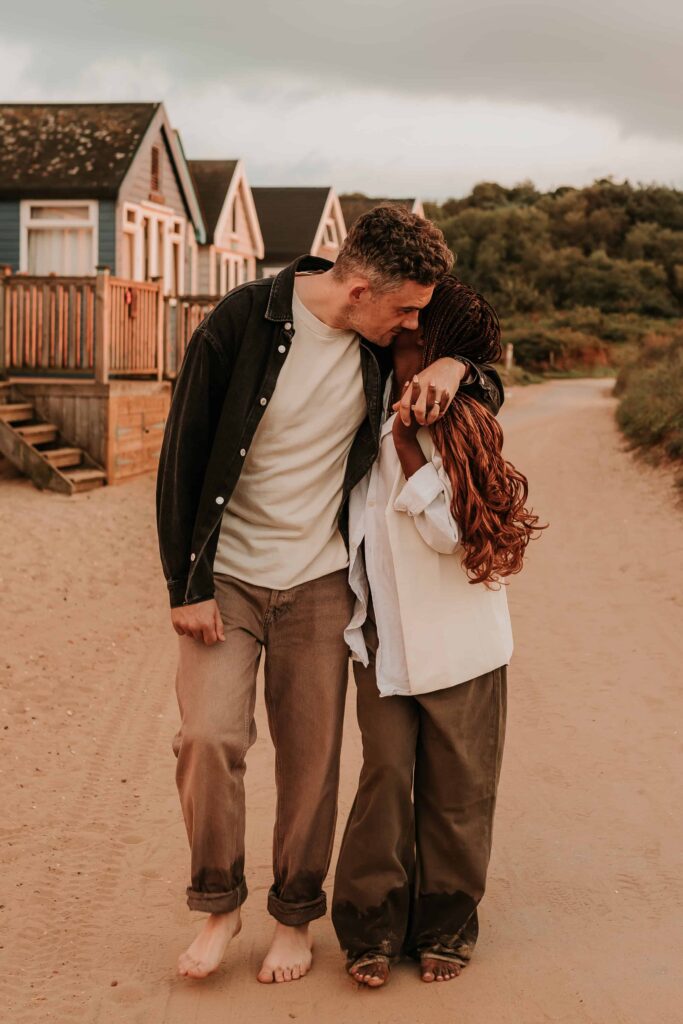 man walking with his arm around pregnant wife