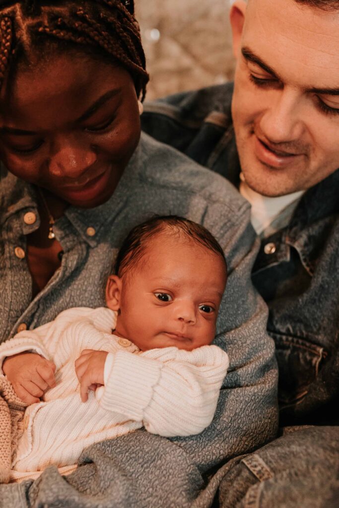 mum and dad cuddle holding newborn baby girl at maternity & newborn photoshoot