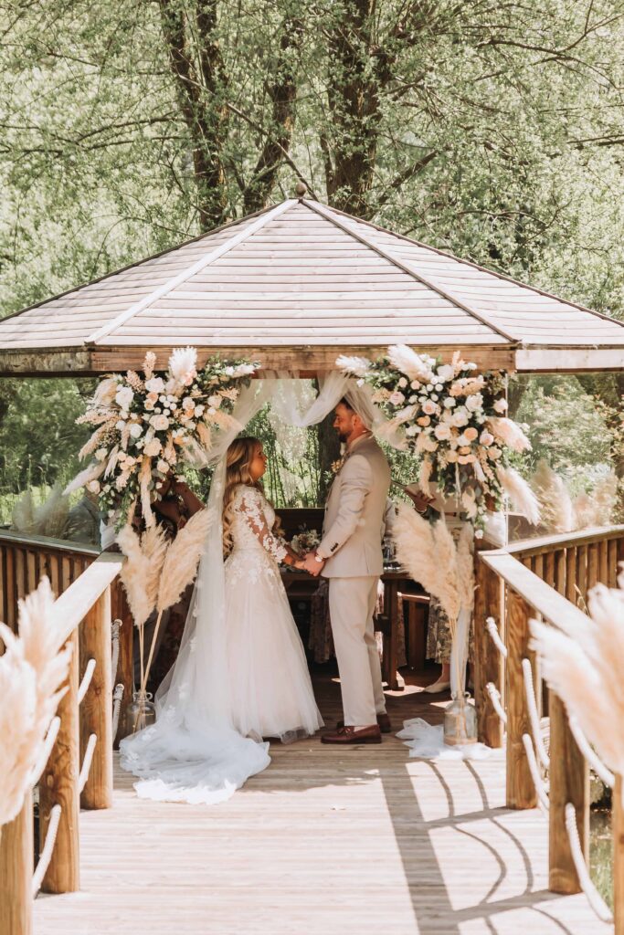 bride and groom holding hands during ceremony at chycara wedding