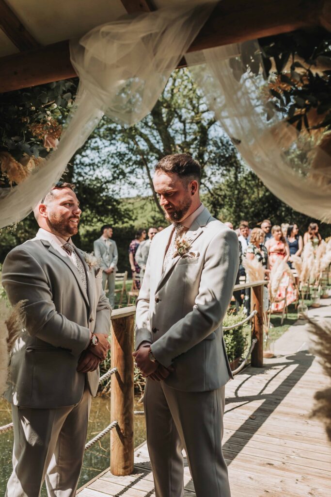 groom waiting at the end of the aisle at chycara wedding