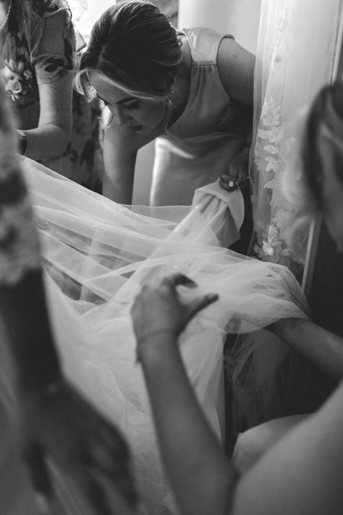 bridesmaids sorting wedding dress