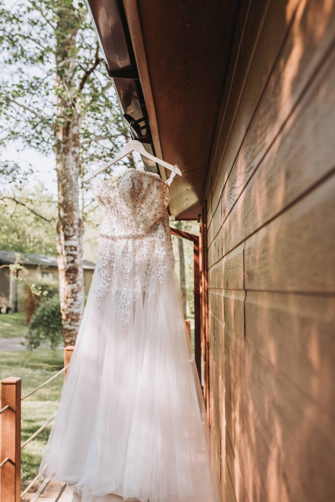 dress hanging from lodge at chycara wedding