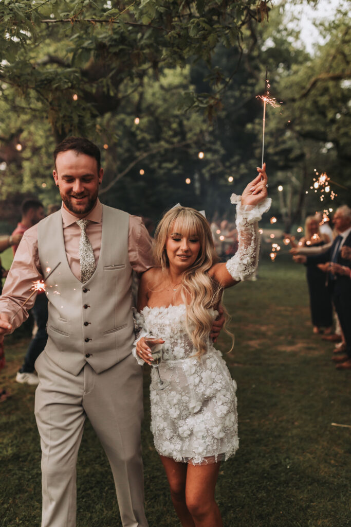 bride and groom running through sparkler exit