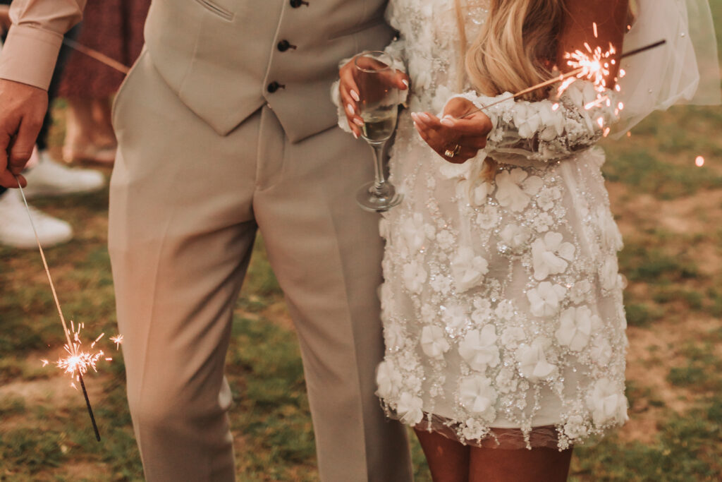 bride and groom holding sparklers