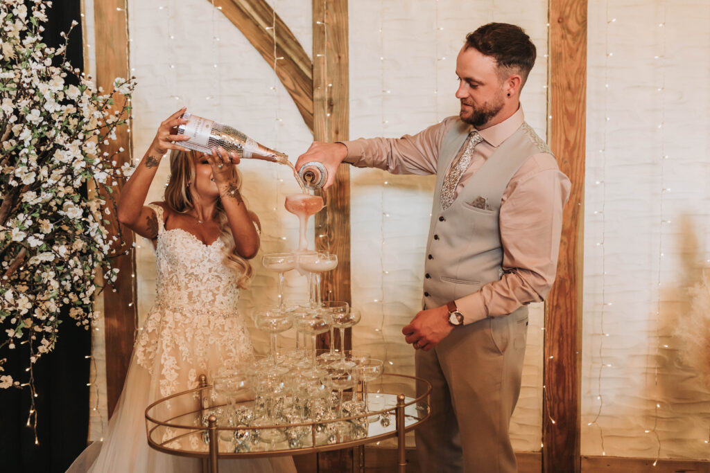 bride and groom pouring champagne tower