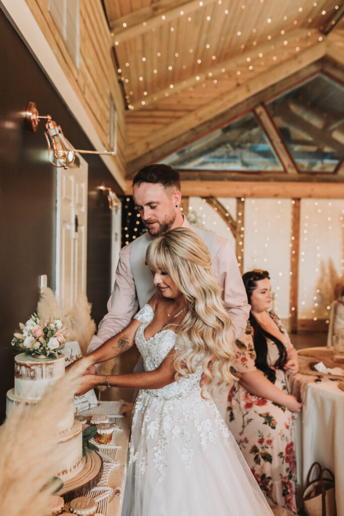 bride and groom cutting cake at chycara wedding