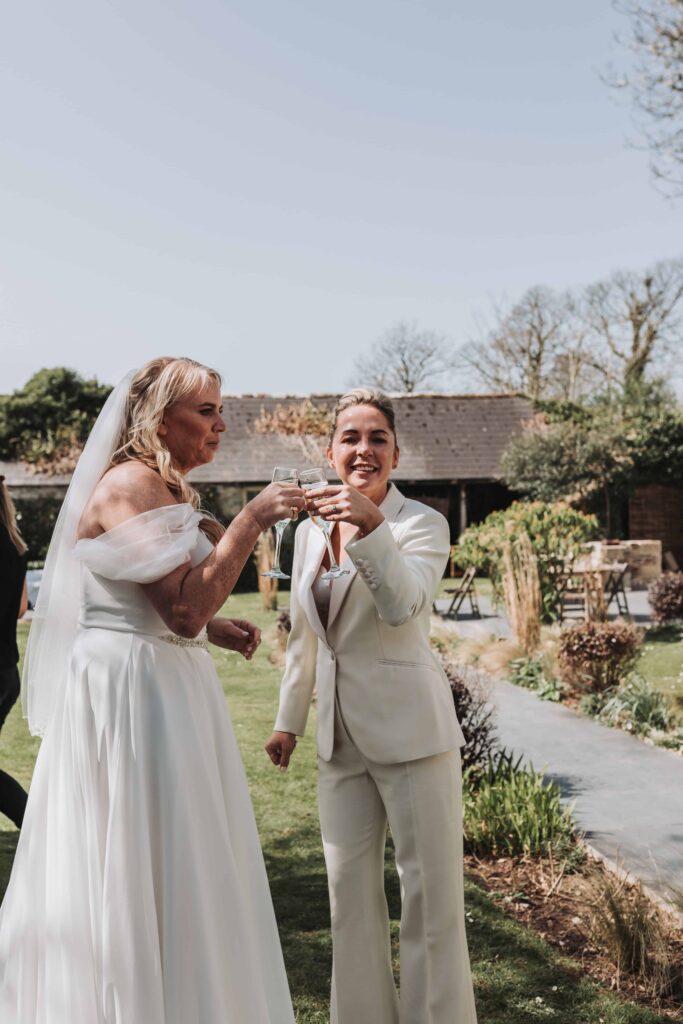 two brides clinking drinks