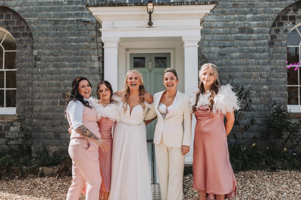 family photo with two brides and daughters outside treseren