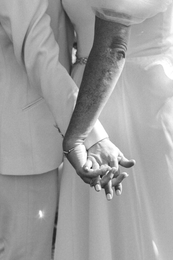 two brides holding hands photo by lgbtq+ wedding photographer