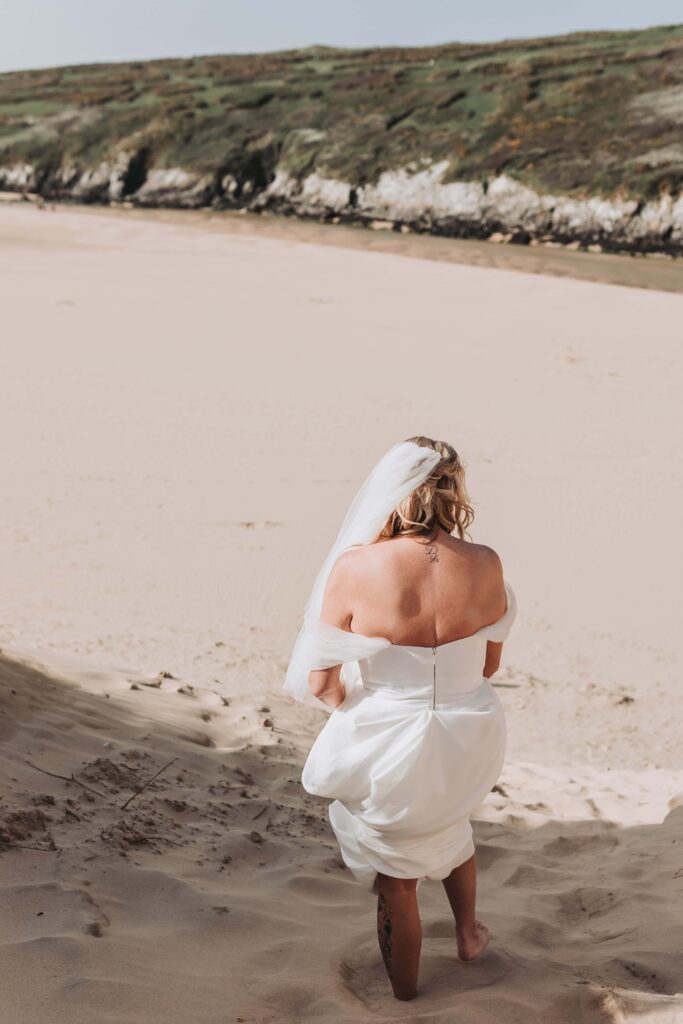 bride walking down cornish sand dune