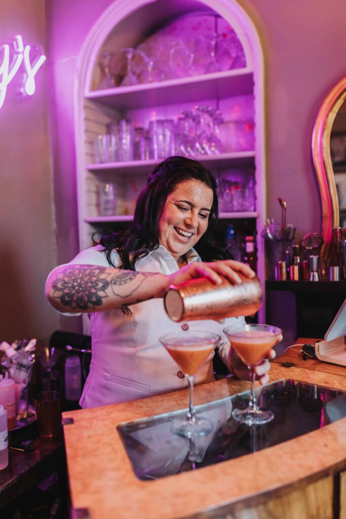 bridesmaid pouring cocktail at treseren