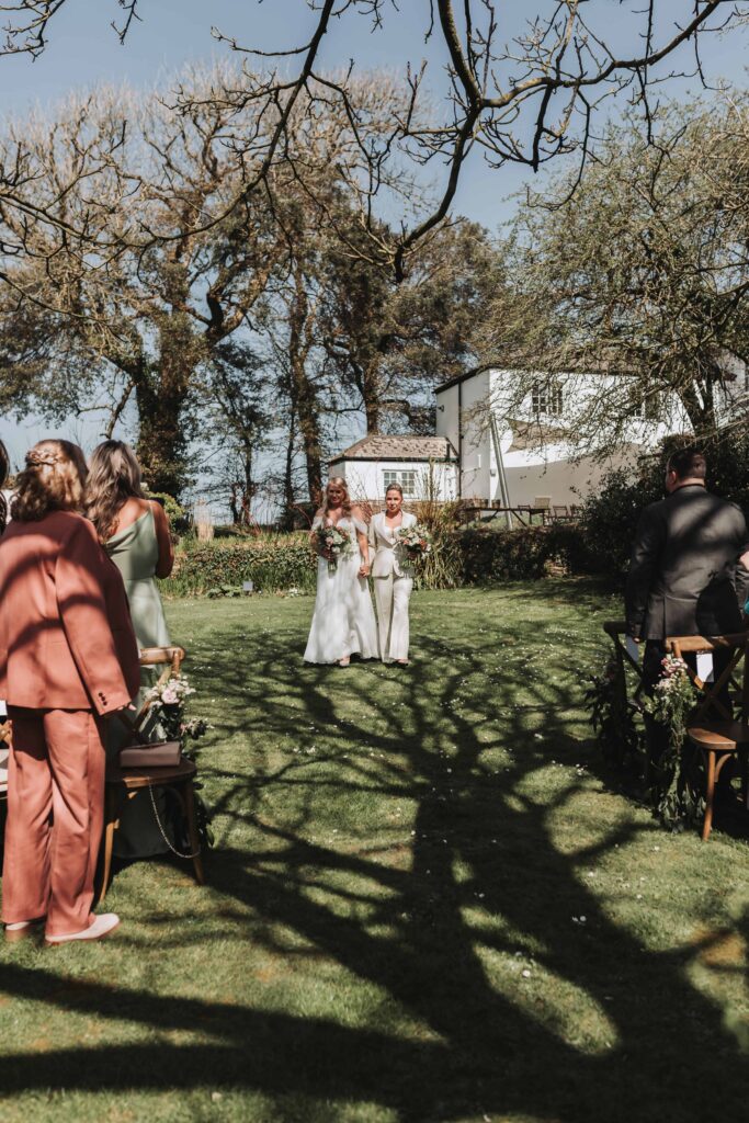 two brides walking down the aisle at treseren