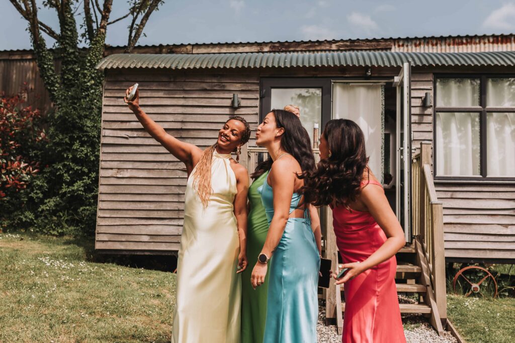 bridesmaids taking a selfie at the green cornwall