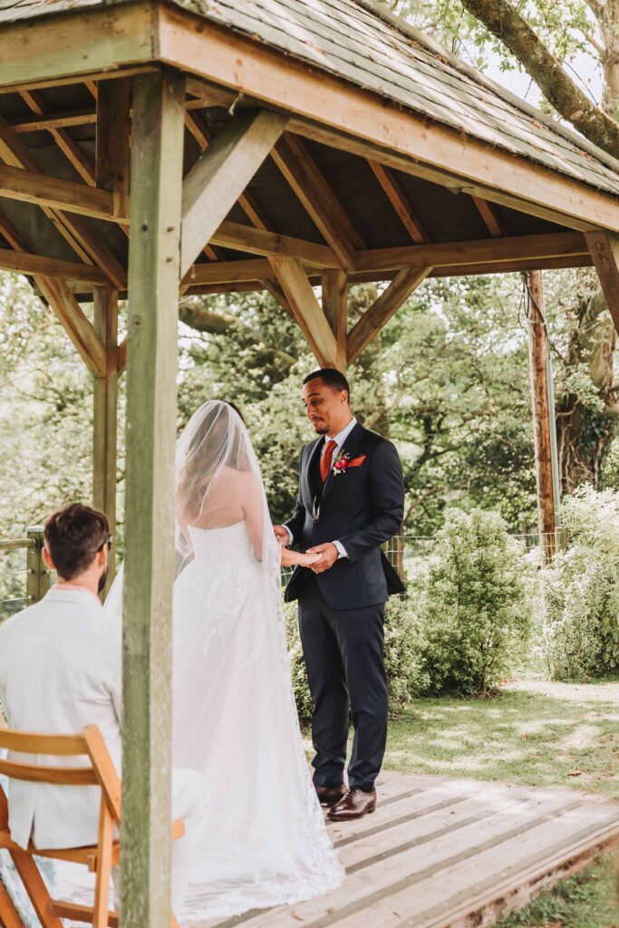 bride and groom at the end of the aisle holding hands