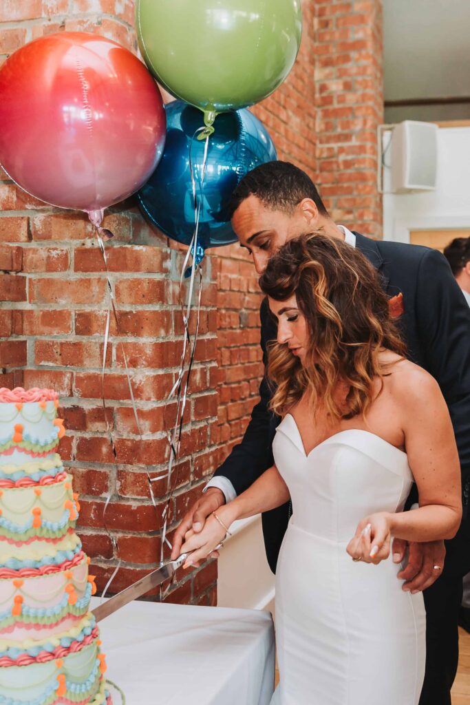 bride and groom cutting the cake at the green cornwall