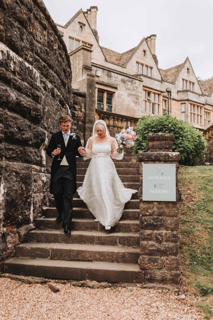 bride and groom walking around coombe lodge bristol