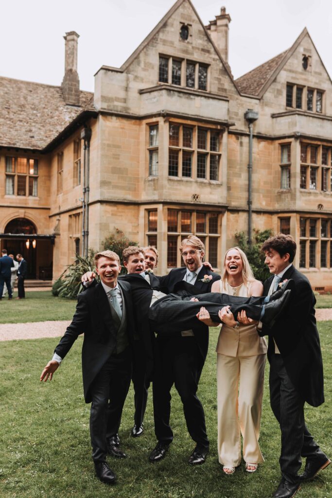 grooms party carrying groom at coombe lodge