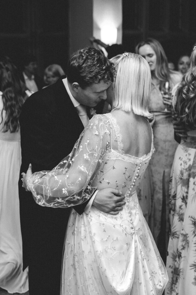 bride and groom holding eachother for first dance