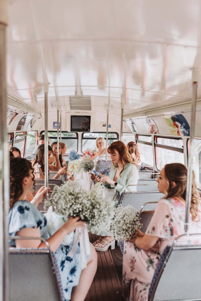 bridesmiads and flower girls waiting in london bus at bristol wedding