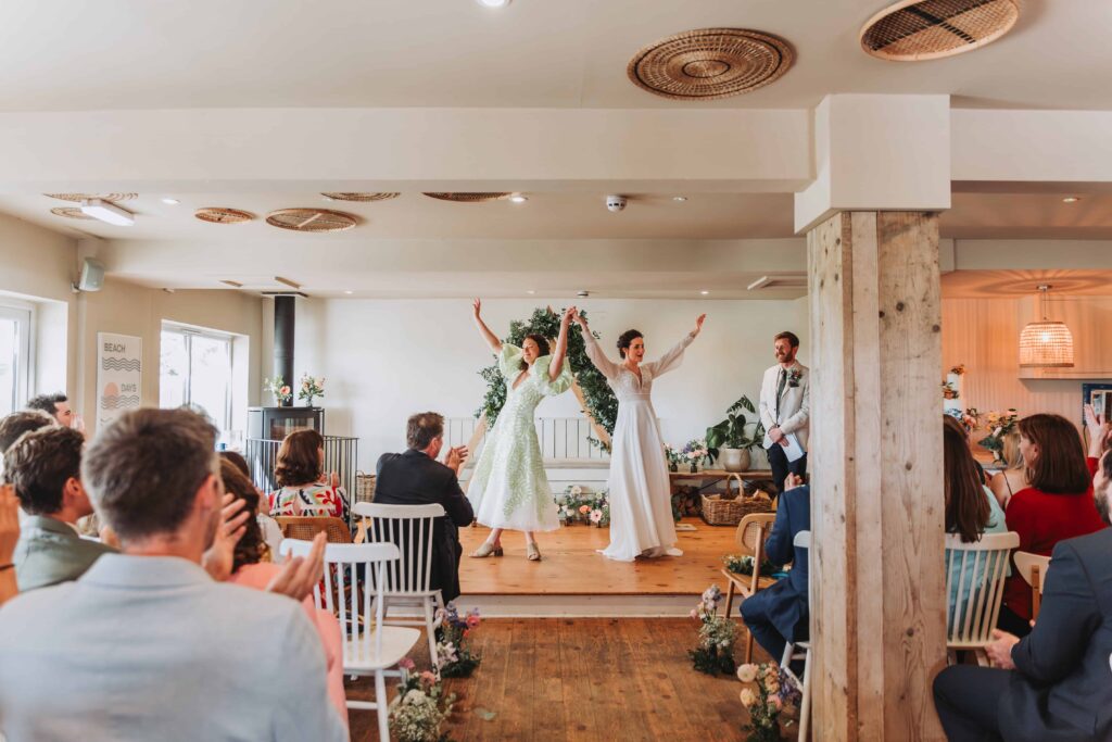 brides cheering after ceremony