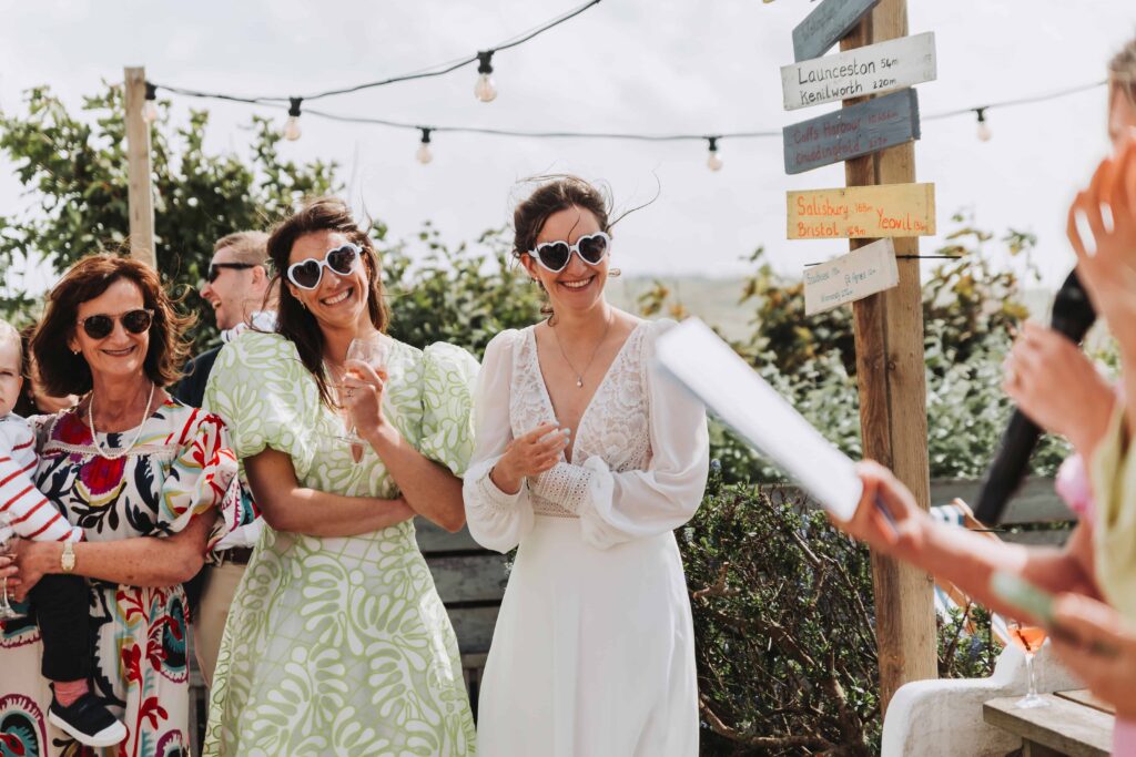 two brides watching friend doing a speech