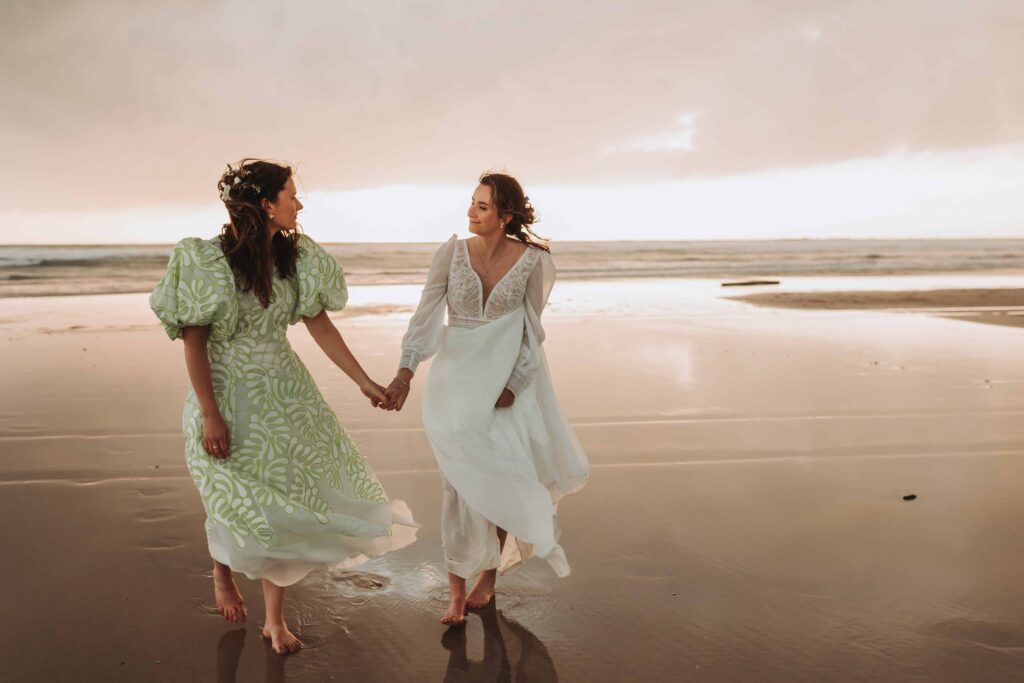 brides looking at each other on godrevy beach