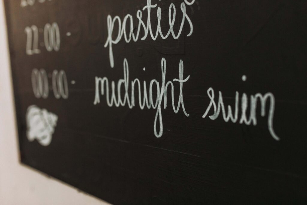 sign showing time of midnight swim