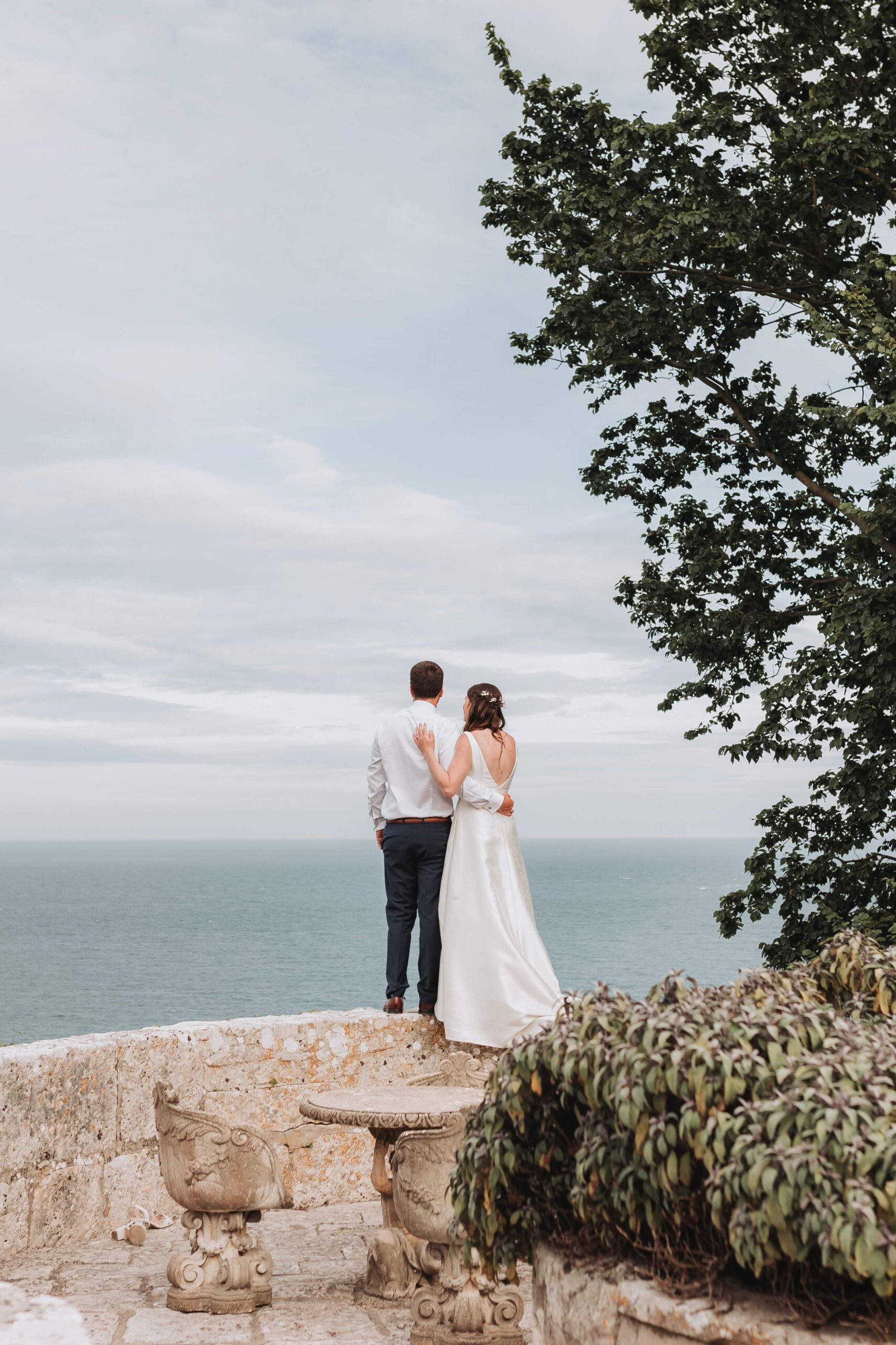 bride and groom looking out to sea at pennsylvania castle estate
