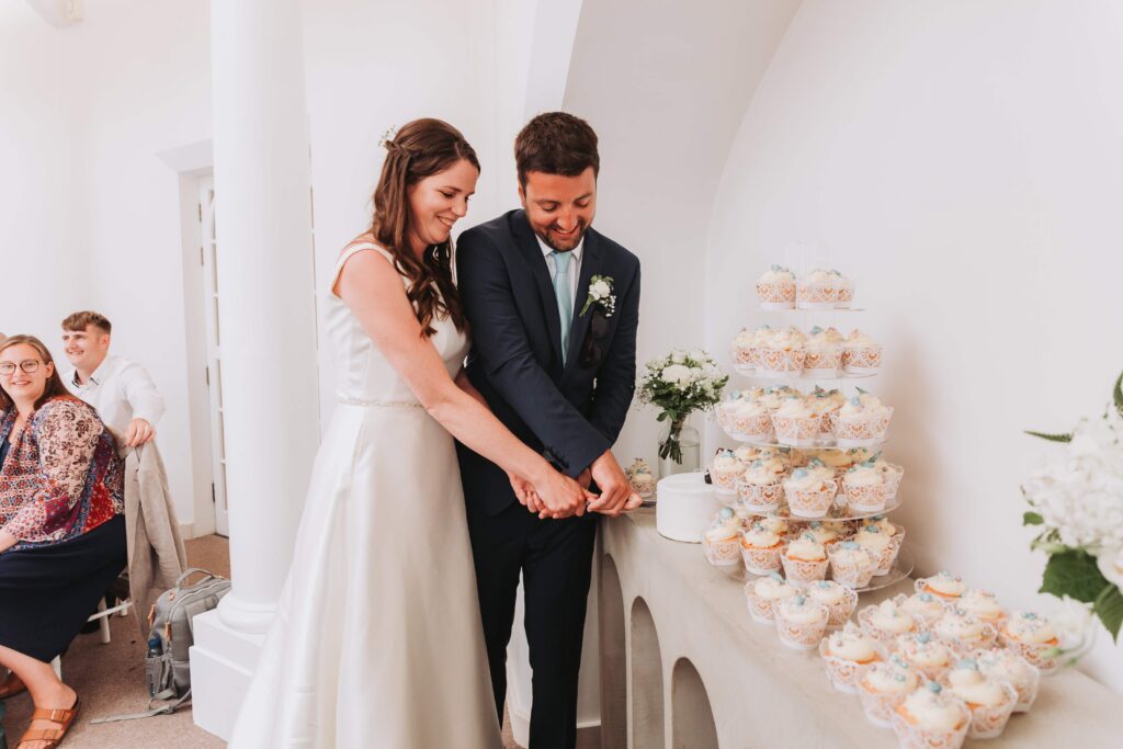 bride and groom cutting wedding cake at pennsylvania castle estate